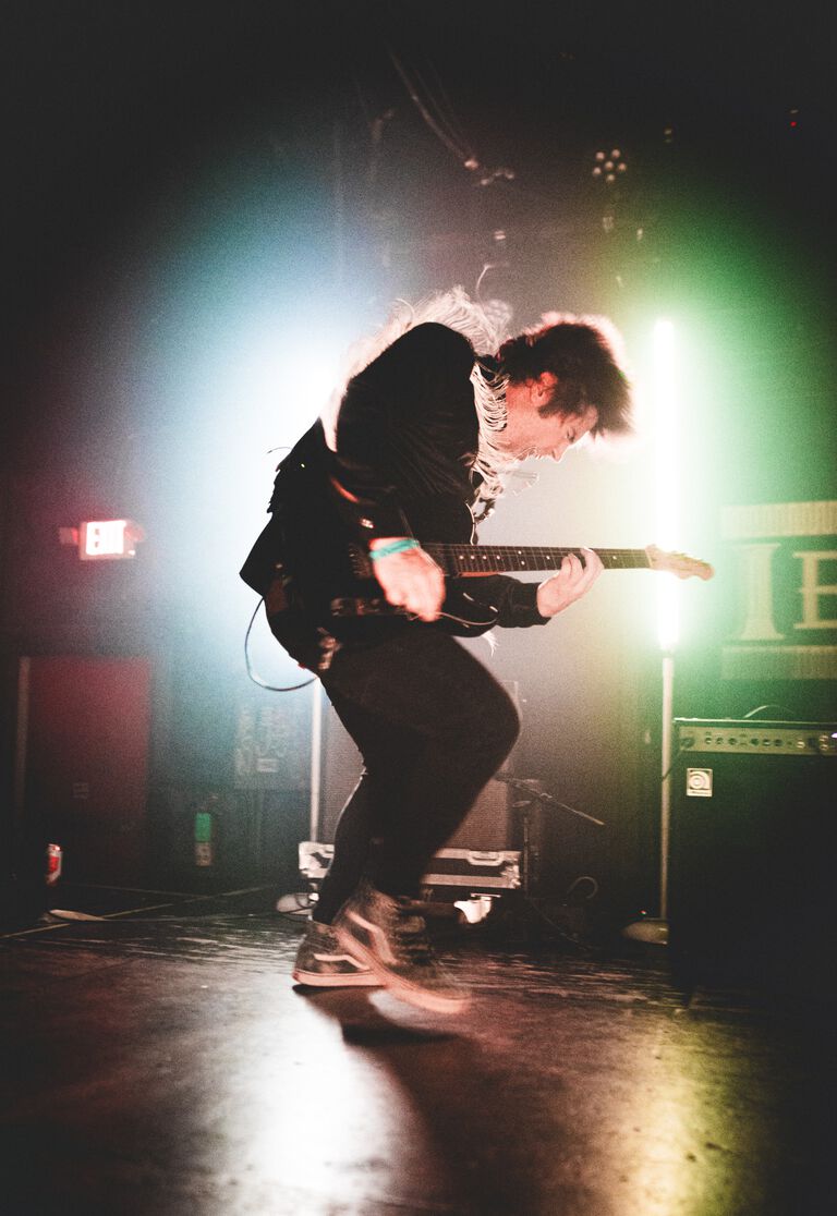 Blake Arambula playing guitar on stage