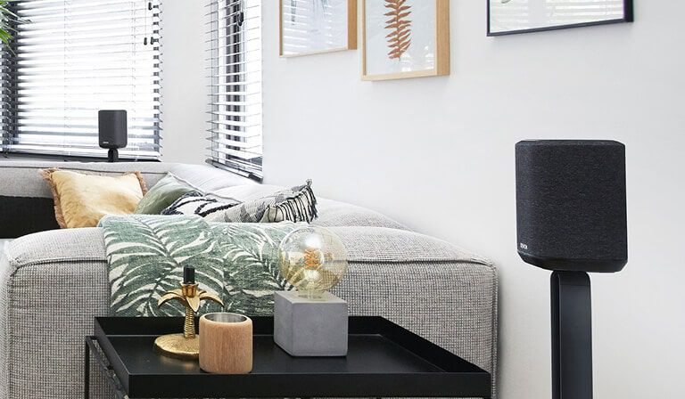 Surrounds placed behind a couch