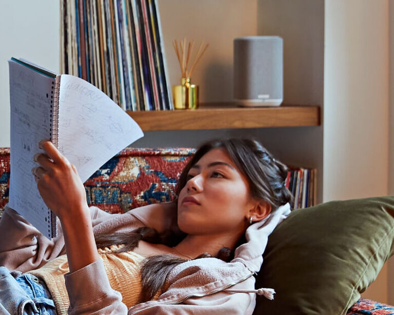Student studying while listening to multi-room audio